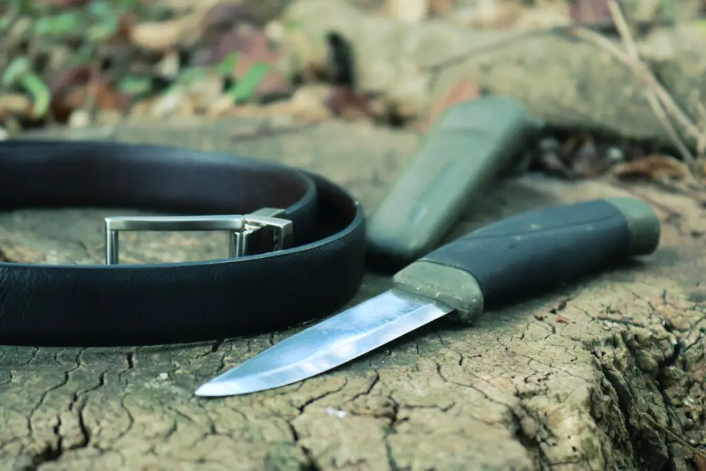 a dull knife with a leather belt