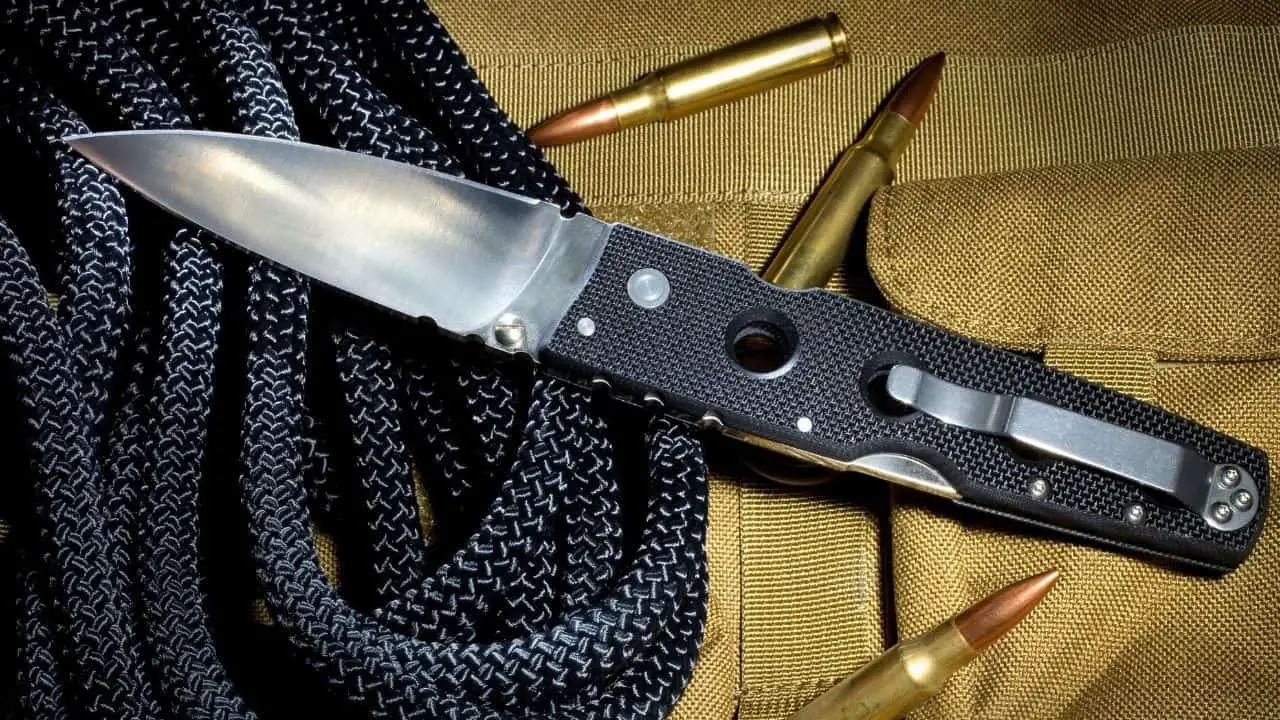 photo of a black folding knife with holes in its handle