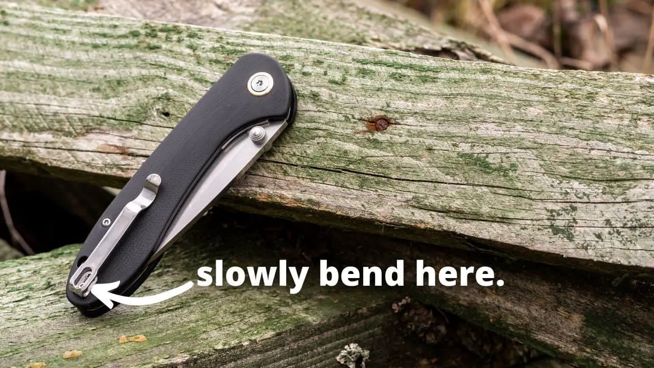 photo of a closed pocket knife with text: "slowly bend here."