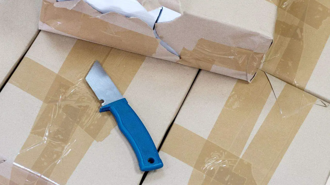 photo of cardboard boxes with lots of tape and a knife