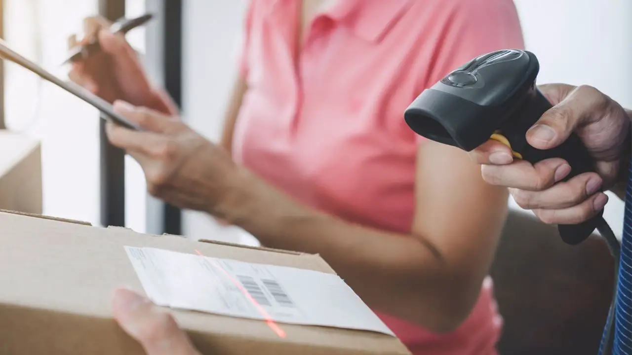 photo of a package being scanned before mailing