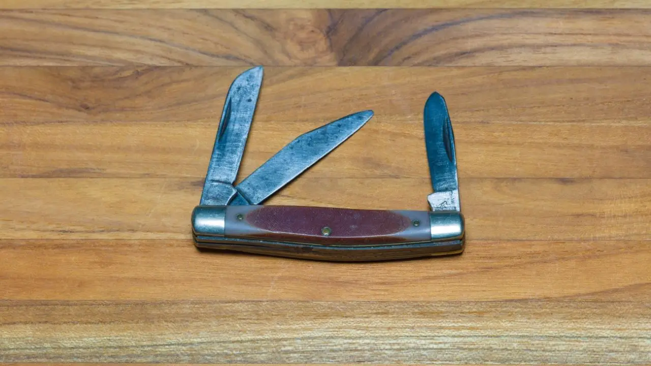 photo of a case pocket knife with three blades open on a wooden surface